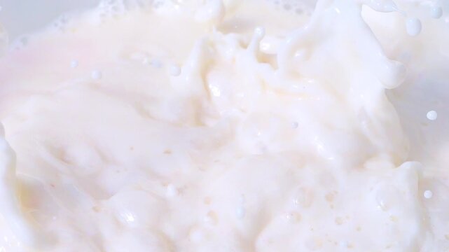 Raspberries falling into milk with splashes in slow motion 300fps