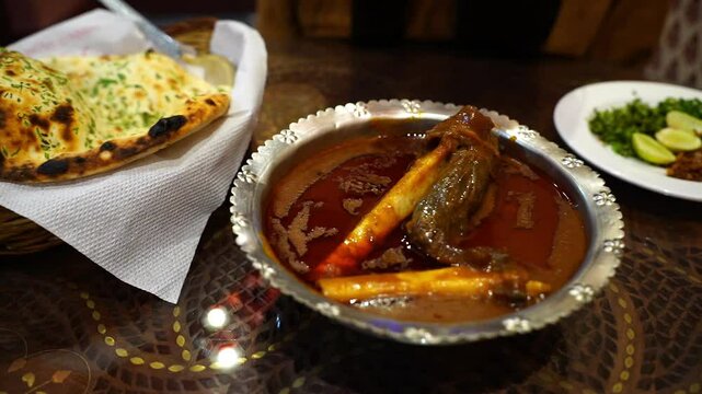 Indian cuisine of naan and mutton Nalli Nihari served at a restaurant names Man o salva in India.