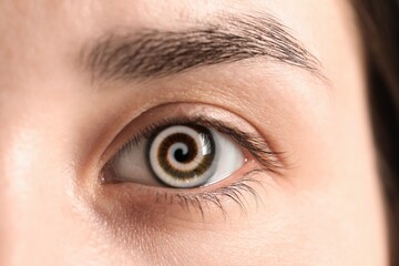 Hypnosis. Spiral symbolizing hypnotic effect in woman's eye, closeup