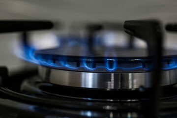 Modern kitchen stove with burning gas, closeup