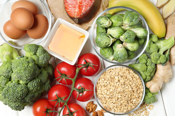 Different fresh products rich in melatonin on white wooden table, flat lay