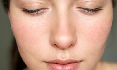 Fototapeta premium a person’s face highlighting the natural texture of the skin with visible pores on the cheeks nose