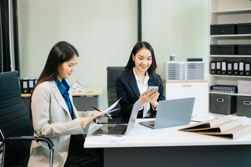 Businesswomen work and discuss their business plans. A woman employee explains
