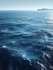 Fototapeta premium Calm ocean waves with distant land.