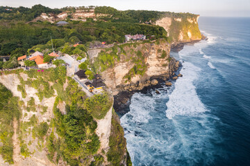 High angle view landscape background of sea cliff sunset with Uluwatu temple in Bali, Indonesia