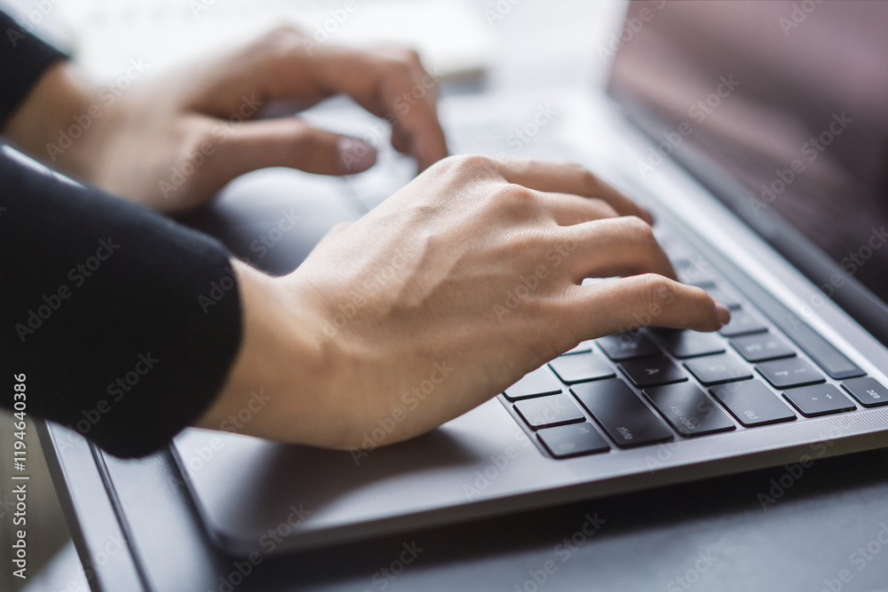 Poster in the blurred setting of an office, a close-up shot captures a woman's hands typing on a modern lap
