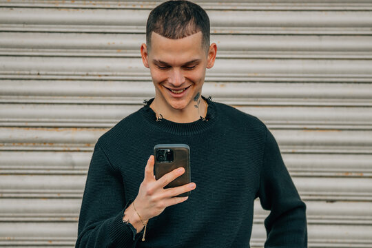 portrait young man on the street with smartphone or cell phone and bicycle - Powered by Adobe