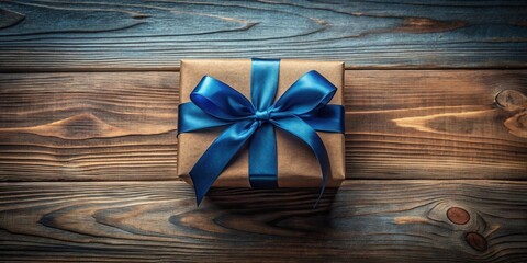 Naklejka premium A Beautifully Wrapped Gift Box with a Blue Ribbon on Wooden Surface