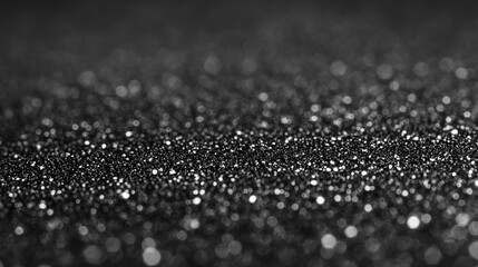 Glittering particles create a mesmerizing effect in an abstract black background