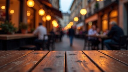 Empty brown wooden table surface with abstract blurred background of street cafe with cozy city night lights and people sitting at the tables. copy space for product display or presentation object