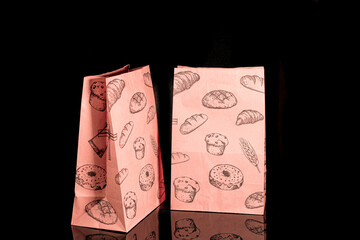 Recyclable craft paper bag for purchases, gifts and takeaway food mock up on black background. Environmentally friendly than single-use plastic bags