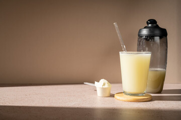 Protein shake and vanilla protein powder in a scoop, collagen, creatin, food supplement
