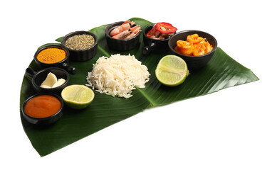 Cut banana leaf with different food, spices and sauce isolated on white. Healthy eco serving