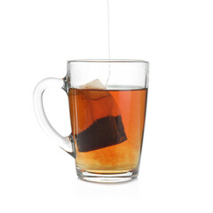 Cup with teabag isolated on white. Brewing aromatic tea