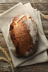 Freshly baked bread and spikes on wooden table, top view
