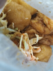 Cilok in plastic. Cilok is a snack made from tapioca flour and served with savory and spicy peanut sauce. aci meatballs.