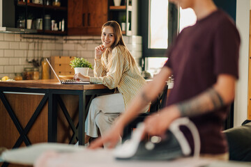 Lesbian couple sharing housework and working remotely