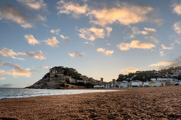 Tossa de Mar beach seen at sunset with warm light and castle, famous tourist destinatio in the...