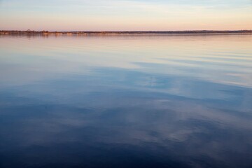 Lake Surface at Sunset with Golden Reflections and Gentle Sky Colors