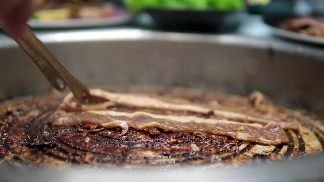 Traditional Romanian foods mititei, slanina and pork meat cooking over wood fire