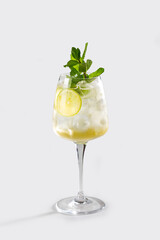 Fresh Hugo Spritz cocktail with lemon, mint and ice, stock, on white background