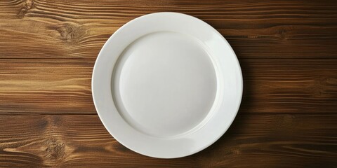 Empty white plate centered on a rustic wooden table, showcasing a clean surface and smooth edges, ideal for kitchen and cookware themes.