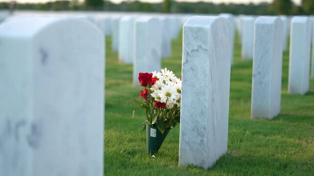 Memorial Day concept. Sarasota National Cemetery with rows of white tomb stones on green grass.
