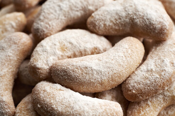 Closeup of homemade Christmas cookies called Kipferl or vanilla crescents coated in sugar