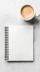 Expenses forecasts prepared in a photo of a blank notebook beside a coffee cup.