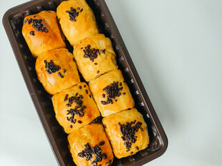 Banana cake or bolen sprinkled with chocolate sprinkles isolated on white background