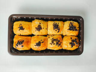 Banana cake or bolen sprinkled with chocolate sprinkles isolated on white background