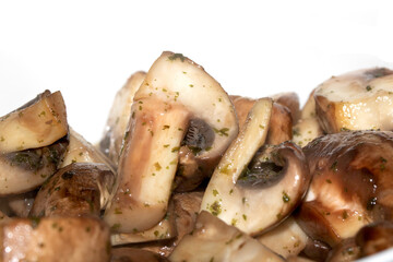 Close Up of a Chopped and Fried Cooked Chestnut Mushroom with Parsley Herb on White Background