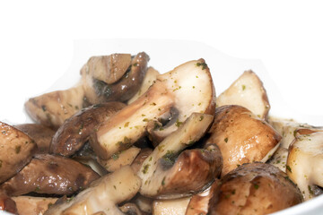 Close Up of a Chopped and Fried Cooked Chestnut Mushroom with Parsley Herb on White Background