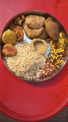 Food items consumed by Bengalis during Makar Sankranti festival are Narkel Naru (coconut sweet made with jaggery) Moa (round puffed jaggery rice) and Tilkut sweets and puffed rice rotis with peanut an