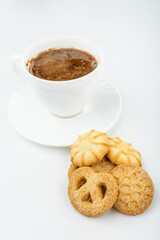 Danish cookies on a white background with coffee in a white cup, freshly brewed American coffee, isolate, breakfast, pastries, delicious shortbread cookies, catalog photo of food, coffee in bed