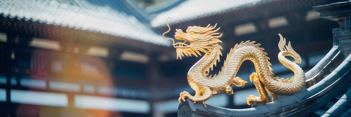 Fototapeta premium Golden dragon sculpture on traditional building with intricate carvings