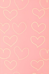 Pink background with yellow textured heart outlines all over the surface.