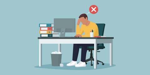 Exhausted employee working in the office: job burnout