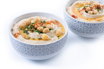Chickpea hummus with olive oil, parsley and paprika in bowl isolated on white background