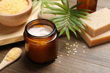 Spa composition with different cosmetic products on wooden table, closeup
