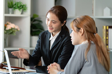 Professional lawyer advising a client about contract details in a modern office setting