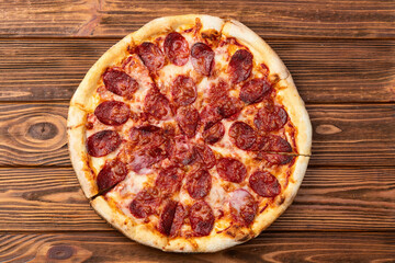 Pizza pepperoni fast food . Top view on rustic background