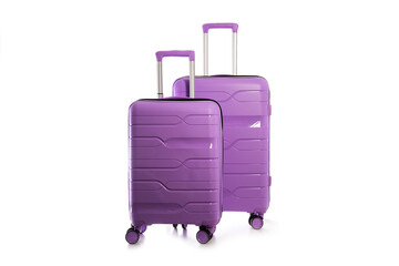 Two modern purple plastic suitcases on a white background, close-up, isolate