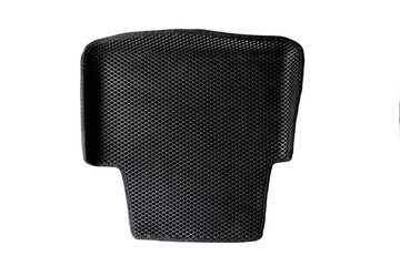Black car mat made of high quality rubber on a white background, isolate, close-up.