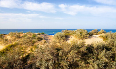 beautiful nature dunes with sands against the backdrop of the sea and sky with clouds on the...