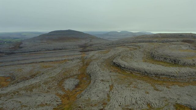 Dynamic aerial pan showcasing the Burren Rocky Mountains. County Clare, Ireland