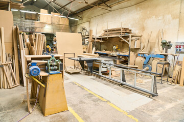 Woodworking workshop filled with tools and raw materials for carpentry