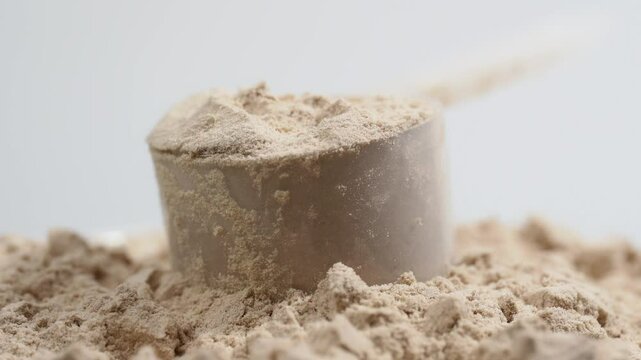 Protein powder in a measuring spoon. Bodybuilding, fitness and lifestyle in the gym. The concept of sports, health and nutrition