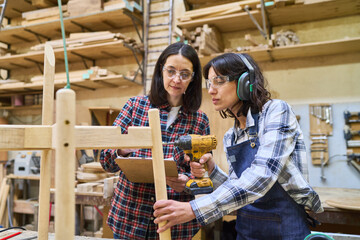 Teamwork and mentorship in a busy lumber workshop