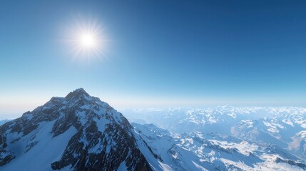 Stunning mountain landscape under a clear blue sky and bright sun.